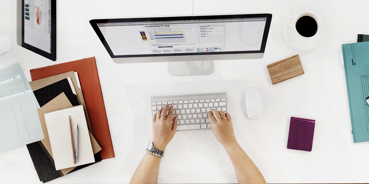 aerial view of hands working on a laptop